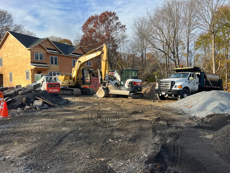Reliable Excavations excavators and trucks on a job site