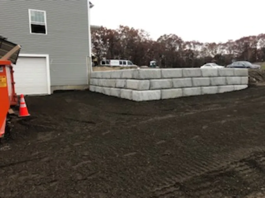 Block retaining wall beside a driveway